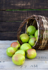 Healthy organic apples in a basket on a wooden background. The concept of a healthy diet.