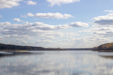 Beautiful, wide river autumn among the woods.