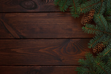 Christmas tree, cones on a wooden brown background.Copy space for your text. Flat lay. New year christmas background