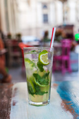 Non-alcoholic or alcoholic mojito on table at summer cafe
