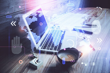Double exposure of desktop with computer and world map hologram. International data network concept.
