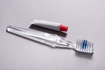 Single use disposable toothbrush with small tube of toothpaste