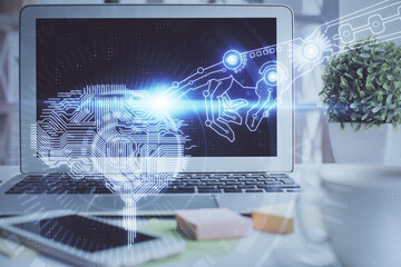 Double exposure of work space with computer and human brain drawing hologram. Brainstorm concept.