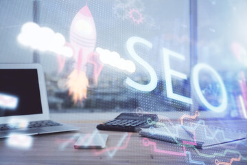 Multi exposure of table with computer and seo drawing hologram. Search optimization concept.