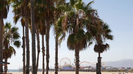 California beach aesthetic, classic ferris wheel, amusement park on pier in Santa Monica pacific ocean resort. Summertime iconic view, palm trees and sky, symbol of Los Angeles with copy space, CA USA