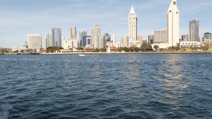 Fototapeta premium Metropolis urban skyline, highrise skyscrapers of city downtown, San Diego Bay, California USA. Waterfront buildings near pacific ocean harbour. View from boat, nautical public transport to Coronado