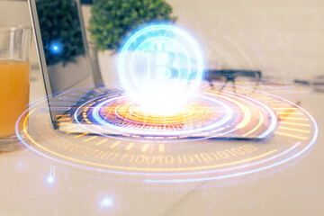 Double exposure of blockchain theme hologram and table with computer background. Concept of bitcoin crypto currency.