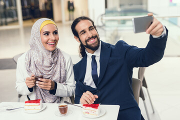 Arabian Couple Sitting in Cafe after Shopping.