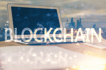 Double exposure of blockchain theme hologram and table with computer background. Concept of bitcoin...