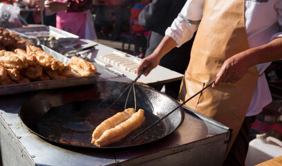 Chinese traditional street breakfast food,Youtiao (deep-fried breadstick) under cooking