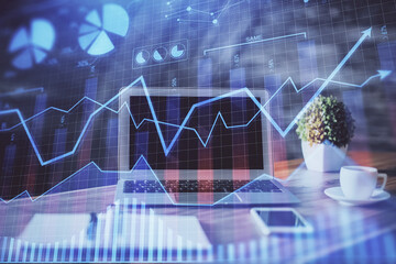 Financial graph colorful drawing and table with computer on background. Double exposure. Concept of international markets.