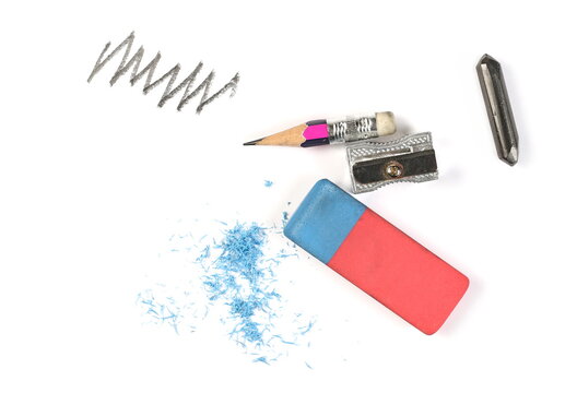 Colorful rubber eraser with graphite pencil, stick, sharpener and line hatching, scribble isolated on white background, top view