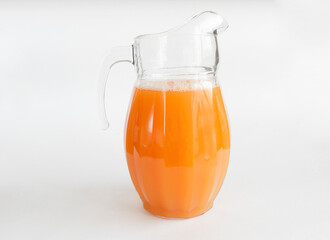 Orange juice in pitcher. Isolated on white background. Copy space