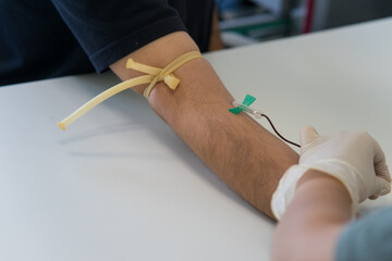 Blood sampling performed with butterfly needle and vacutainer system. Blood taken from the arm.