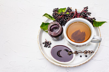 Elderberry jam from ripe berries and hot tea