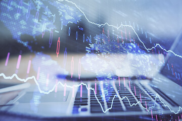 Financial chart drawing and table with computer on background. Multi exposure. Concept of international markets.