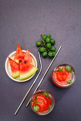 Fresh non-alcoholic fruit cocktail with juicy watermelon, green grape, rosemary and tonic water