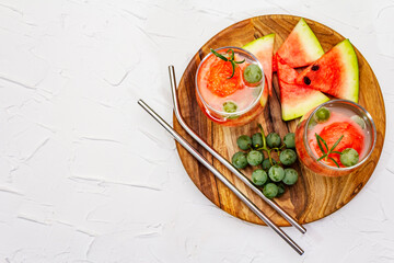 Fresh non-alcoholic fruit cocktail with juicy watermelon, green grape, rosemary and tonic water