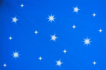 Obraz na płótnie Canvas Snowy winter night. Abstract blue background with bright stars