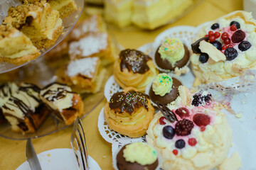 Delicious sweets on candy buffet. Wedding bakes on trays