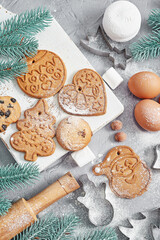 Fototapeta na wymiar Ingredients for cooking Christmas baking. Christmas gingerbread of various shapes. Festive food, family culinary, Merry Christmas and New Year traditions concept.