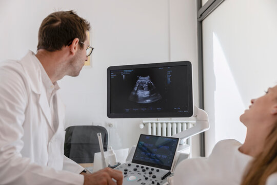 Doctor and patient looking at ultrasound image