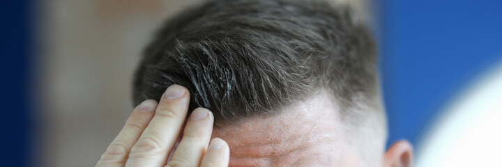 Man applying hair gel to his hair Cosmetics for men concept