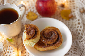 Homemade cinnamon rolls with hot tea, styling with autumn or fall atmosphere