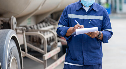 Truck drivers hand holding clipboard Check the product list, Preforming a pre-trip inspection on a truck, spot focus.