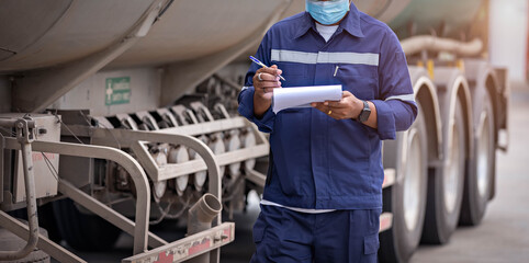 Truck drivers hand holding clipboard Check the product list, Preforming a pre-trip inspection on a...