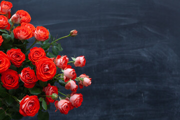 bouquet of roses in hand on a chalkboard background