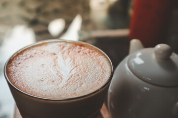 Hot coffee cappuccino with latte art in morning.