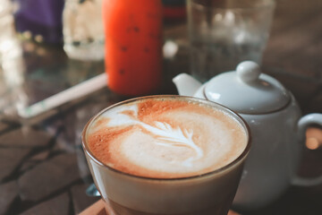 Hot coffee cappuccino with latte art in morning.