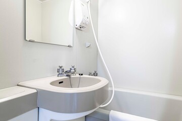 Finished bathtub and wash basin in a small shower room at Japanese hotel