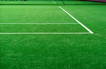 White lined green grass tennis court