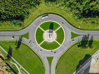 Aerial view of the ring road with a three-way fork on a Sunny summer day. City infrastructure. Beautiful top view of the ring road.