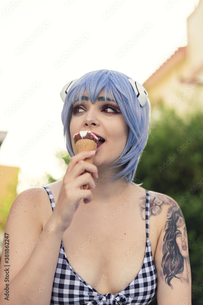 Poster vertical shot of a european female with blue haor eating an ice-cream