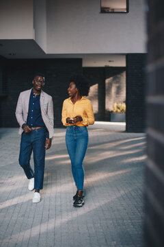 A young beautiful curly girl is on a date with a young man, they talk and smile, a positive impression