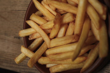 french fries on wooden background