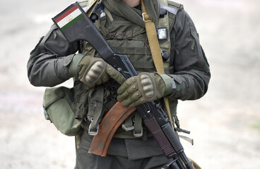 Flag of Tajikistan on assault rifle butt. Collage.