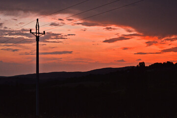 Sunset with a voltage pole