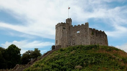 Stunning rotating shot around Cardiff Castle in Wales, UK progressively lit by sunlight. Its construction dates back to 1081