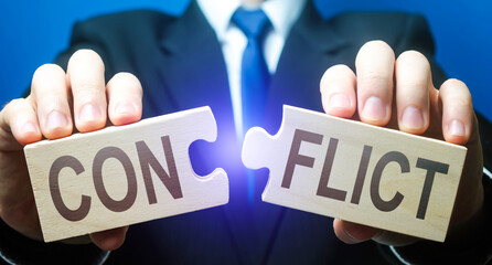 Man breaks puzzles with word Conflict. Resolution of disputes and conflicts in negotiations. Come to a general agreement. Stop confrontation. Mediator. Diplomacy and Geopolitics. Get along with others