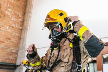 Unrecognizable firefighter with a yellow helmet