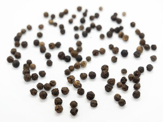 Black pepper hearts, herbs, spices in top view.