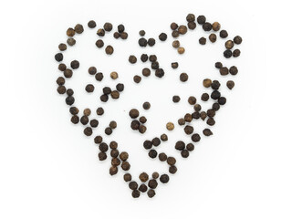 Black pepper hearts, herbs, spices in top view.