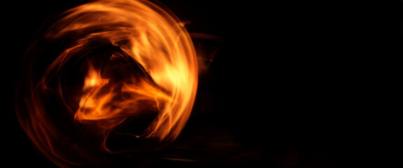 abstract fiery whirlwind on a dark background. flying fireball