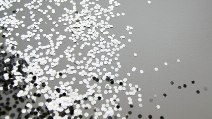 Shiny silver confetti on a white background. For birthday, christmas, wedding, valentine's day, new year