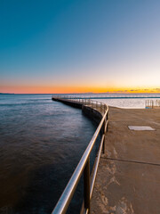 Fototapeta na wymiar Sunrise view of Collaroy Beach rock pool, Sydney, Australia.