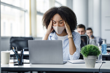 Overwork, illness and disease symptoms in workers. African american woman in protective mask...